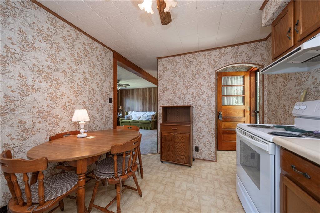 462 Crawford Run Road Cheswick, PA 15024 - Photo 20 of 39 a kitchen with a table chairs a stove and a refrigerator