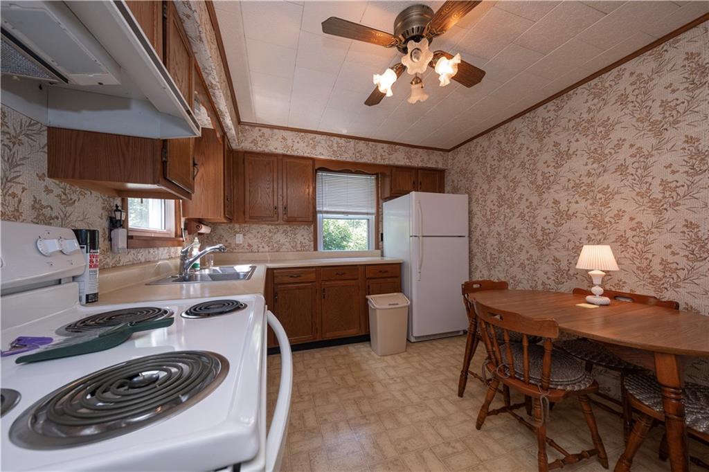 462 Crawford Run Road Cheswick, PA 15024 - Photo 21 of 39 a kitchen with a table chairs and a stove