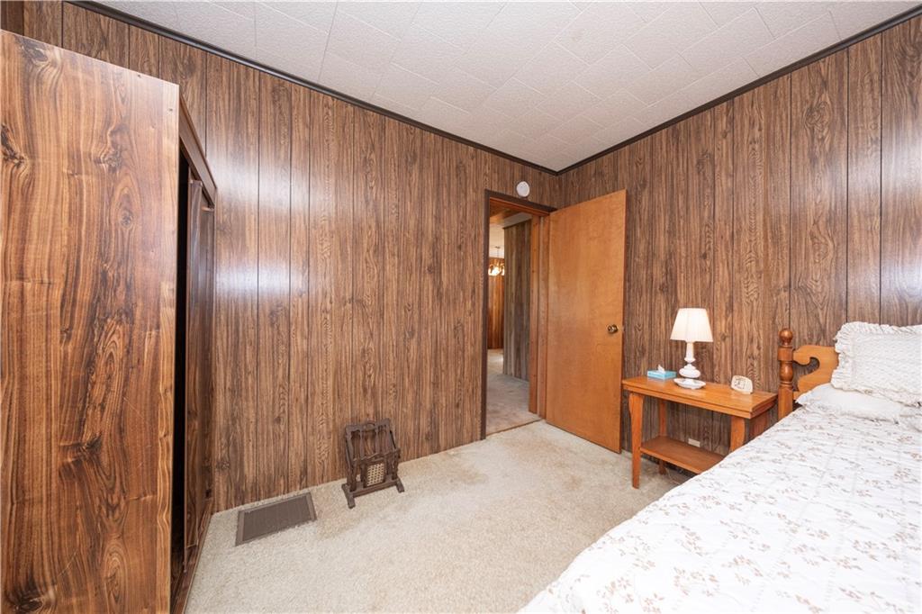 462 Crawford Run Road Cheswick, PA 15024 - Photo 31 of 39 a bedroom with a bed and a chandelier