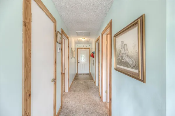 a view of a hallway with wooden shelves