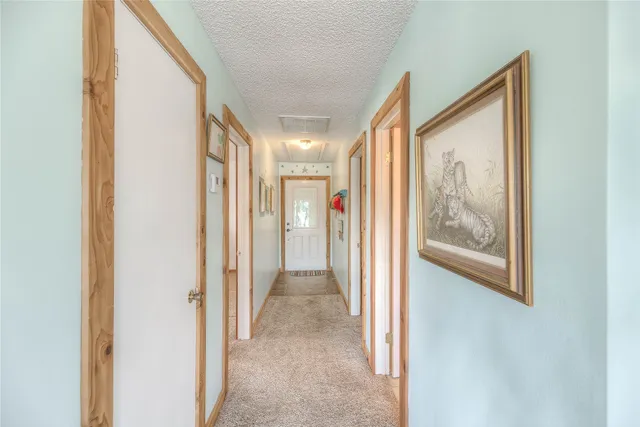 a view of a hallway with wooden shelves