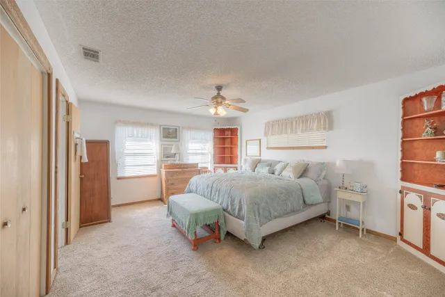 a bedroom with a bed and a cabinets