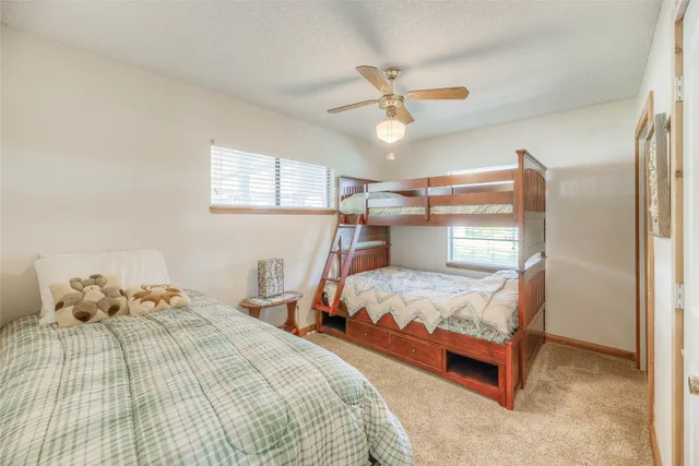 a bedroom with a bed and ceiling fan