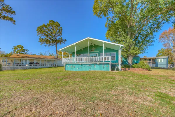 a house with a big yard and large trees