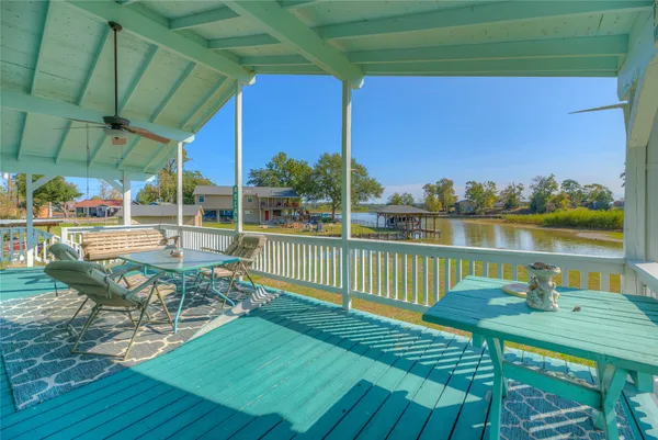 a view of a chairs and table in patio with a barbeque grill
