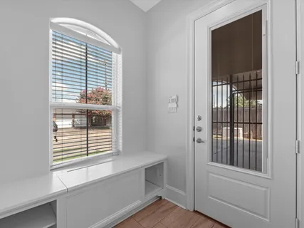 a view of wooden floor and windows in a room