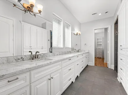 a bathroom with double sink and a mirror
