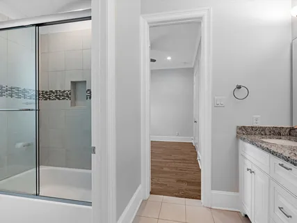 a bathroom with a granite countertop mirror and shower
