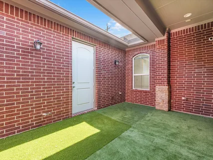 a view of an house with backyard and porch