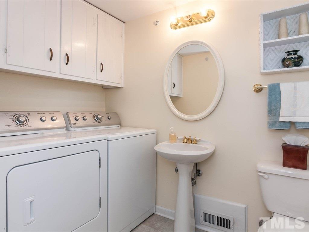 413 Crescent Court Raleigh, NC 27609 - Photo 12 of 25 a bathroom with a sink a toilet and a mirror