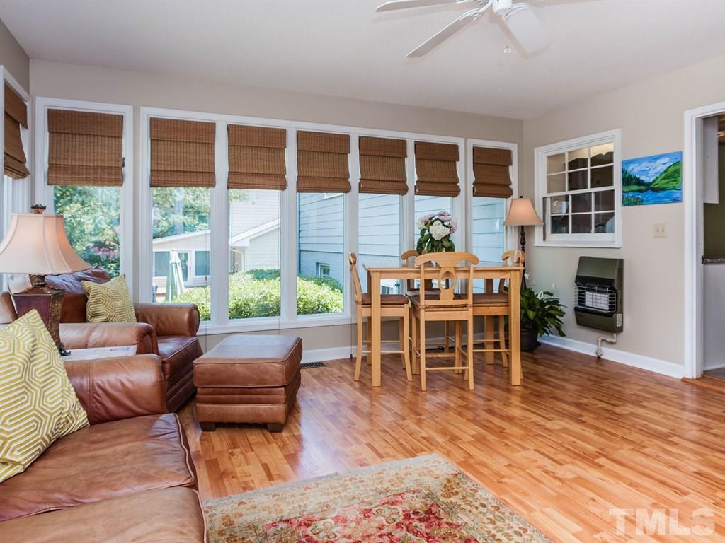 413 Crescent Court Raleigh, NC 27609 - Photo 15 of 25 a living room with furniture a fireplace and a floor to ceiling window