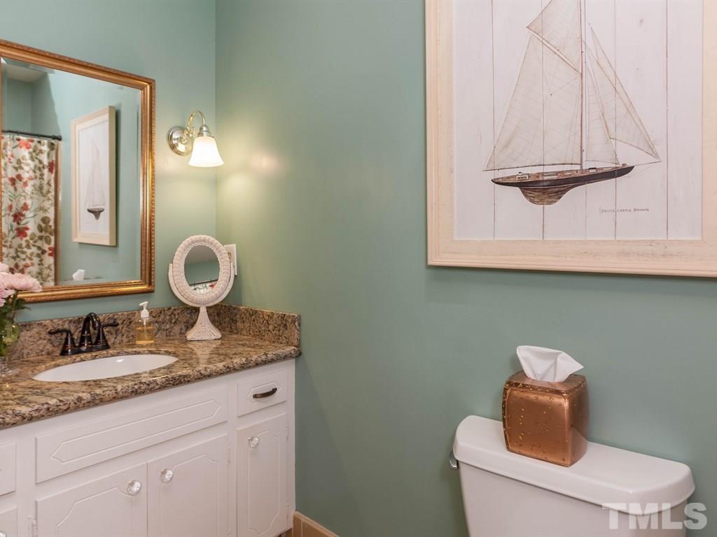 413 Crescent Court Raleigh, NC 27609 - Photo 19 of 25 a bathroom with a toilet sink and mirror