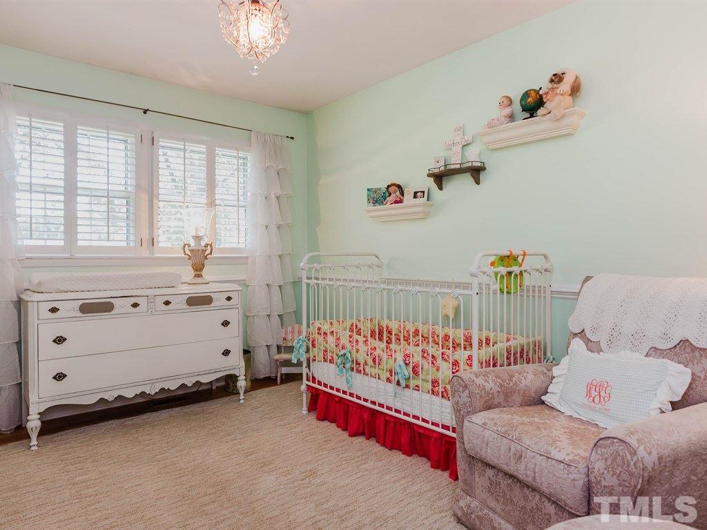 413 Crescent Court Raleigh, NC 27609 - Photo 20 of 25 a bedroom with furniture and a window