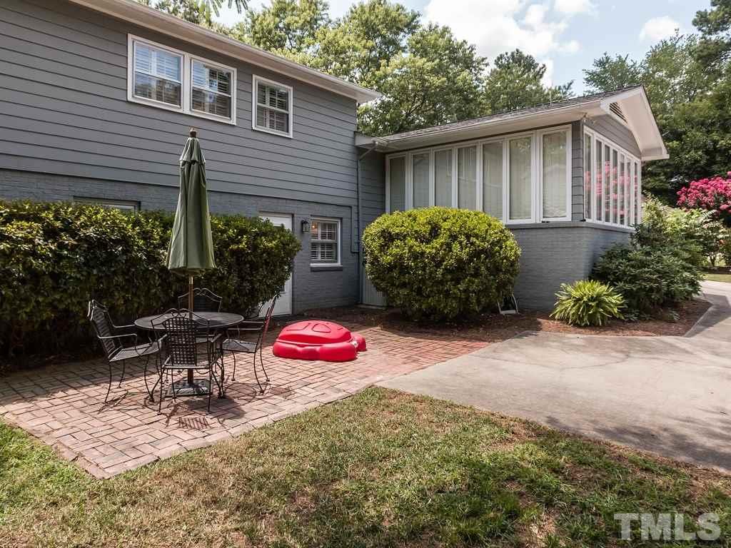 413 Crescent Court Raleigh, NC 27609 - Photo 22 of 25 a view of a backyard with table and chairs potted plants