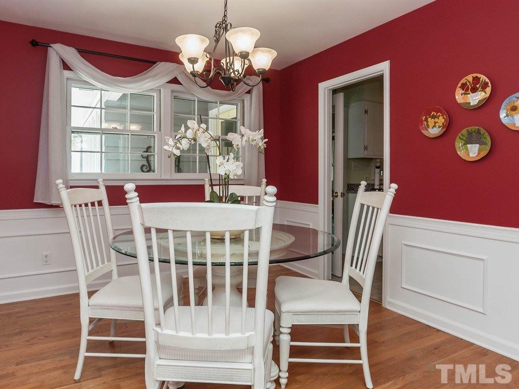 413 Crescent Court Raleigh, NC 27609 - Photo 7 of 25 a view of a dining room with furniture a chandelier and wooden floor