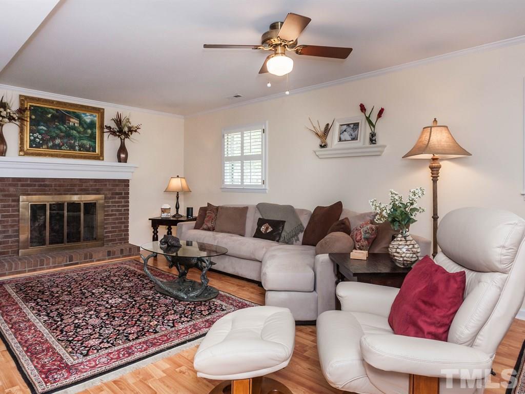 413 Crescent Court Raleigh, NC 27609 - Photo 10 of 25 a living room with furniture a rug and a fireplace