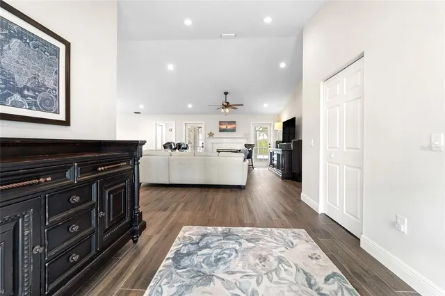 a dining room filled chandelier and wooden floor