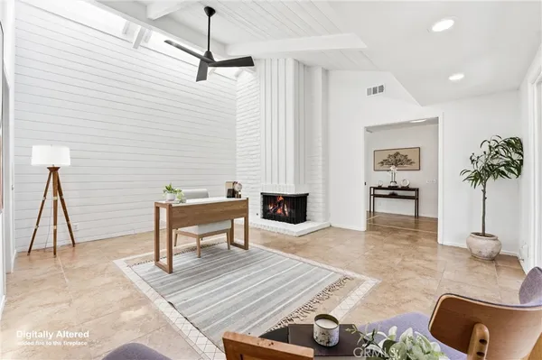 a living room with furniture a couch and a potted plant
