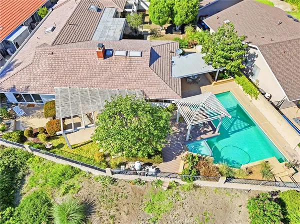 an aerial view of a house with a yard and plants