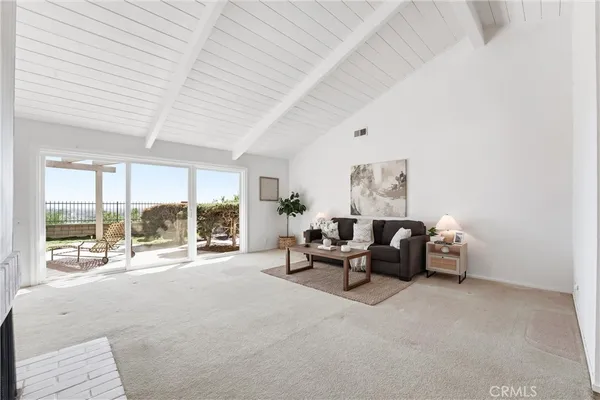 a living room with furniture and large windows