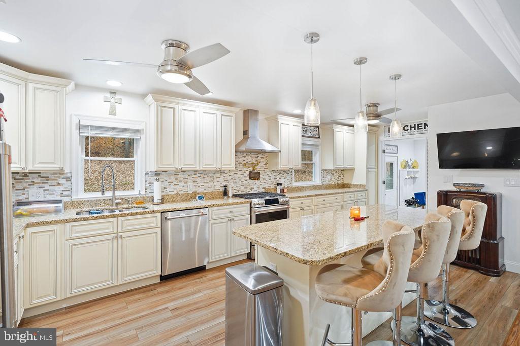 997 Mt Zion Marlboro Road Lothian, MD 20711 - Photo 14 of 58 a kitchen with stainless steel appliances a stove a sink dishwasher a oven with a dining table and chairs