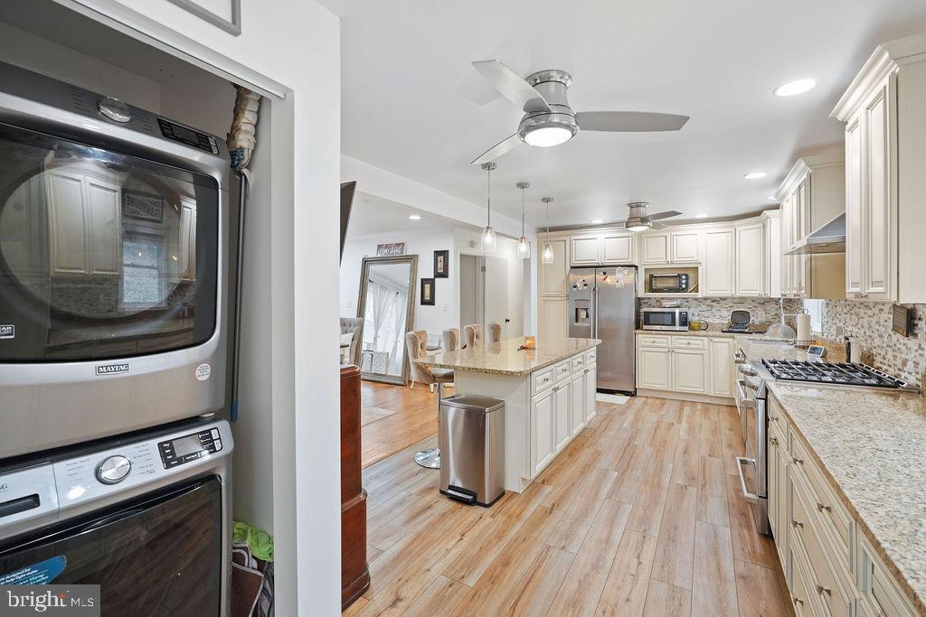 997 Mt Zion Marlboro Road Lothian, MD 20711 - Photo 15 of 58 a kitchen with stainless steel appliances kitchen island granite countertop a stove a sink and a refrigerator