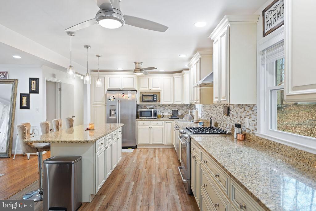 997 Mt Zion Marlboro Road Lothian, MD 20711 - Photo 16 of 58 a large white kitchen with cabinets a sink and stainless steel appliances