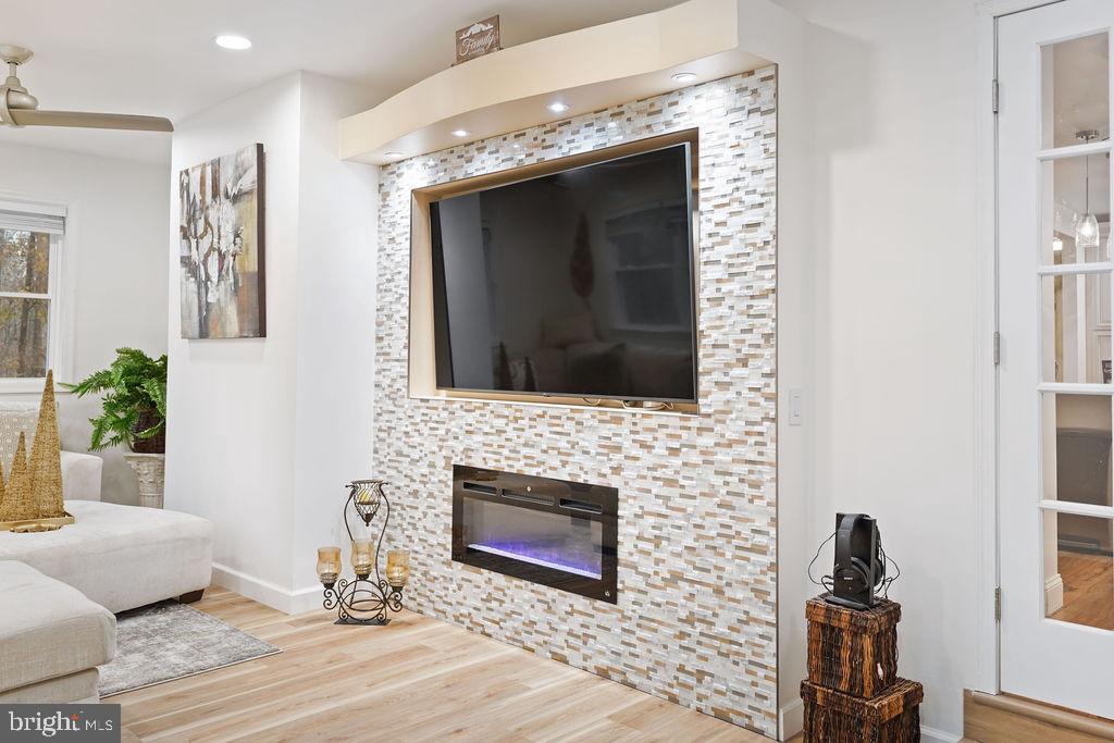 997 Mt Zion Marlboro Road Lothian, MD 20711 - Photo 26 of 58 a living room with a fireplace and a flat screen tv
