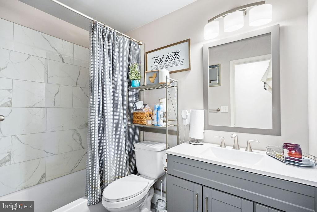 997 Mt Zion Marlboro Road Lothian, MD 20711 - Photo 27 of 58 a bathroom with a sink a toilet and shower curtain