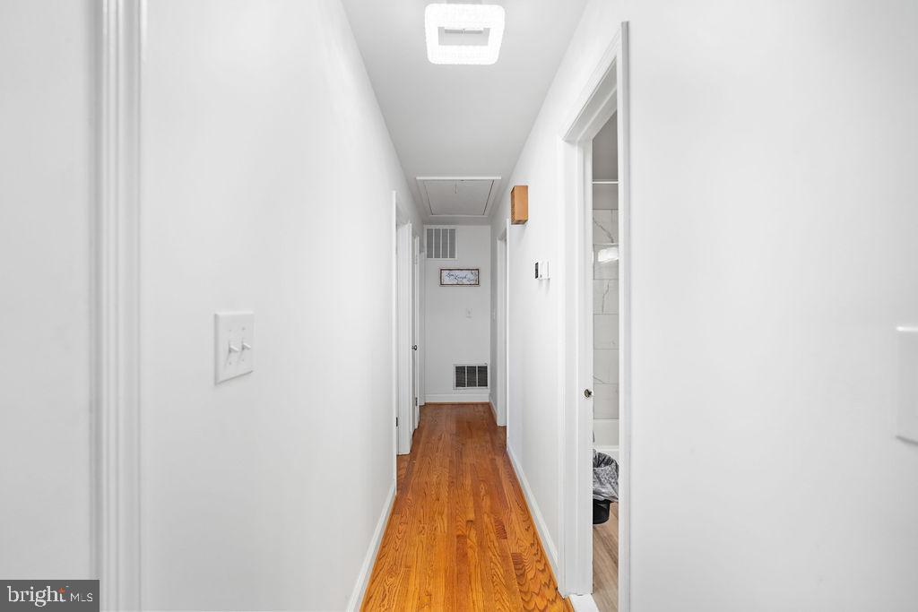 997 Mt Zion Marlboro Road Lothian, MD 20711 - Photo 30 of 58 a view of a hallway with wooden floor and staircase