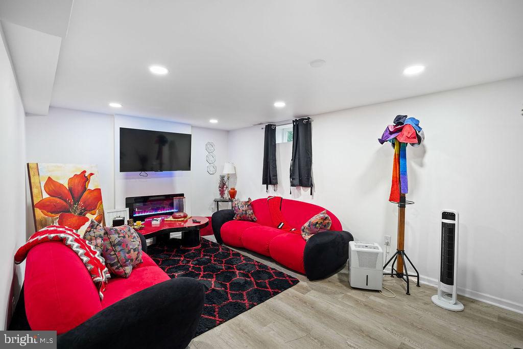 997 Mt Zion Marlboro Road Lothian, MD 20711 - Photo 37 of 58 a living room with furniture a flat screen tv and a fireplace