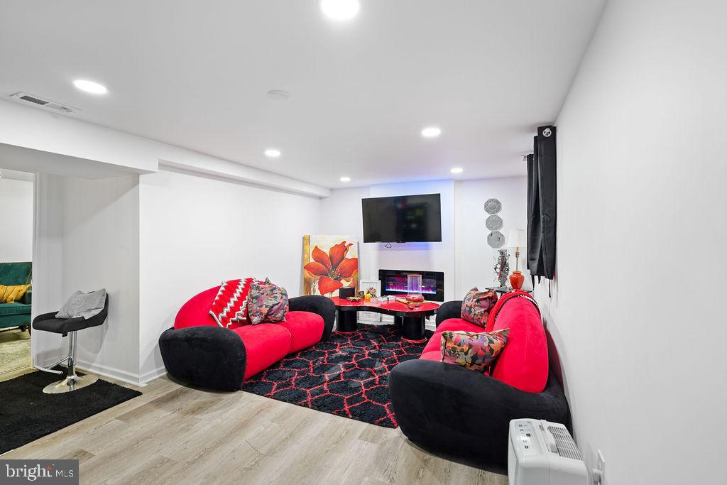 997 Mt Zion Marlboro Road Lothian, MD 20711 - Photo 38 of 58 a living room with furniture a flat screen tv and a fireplace