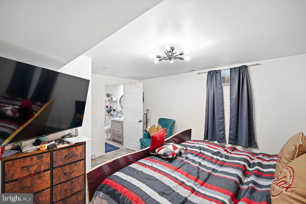 997 Mt Zion Marlboro Road Lothian, MD 20711 - Photo 42 of 58 a bedroom with a bed and a flat screen tv