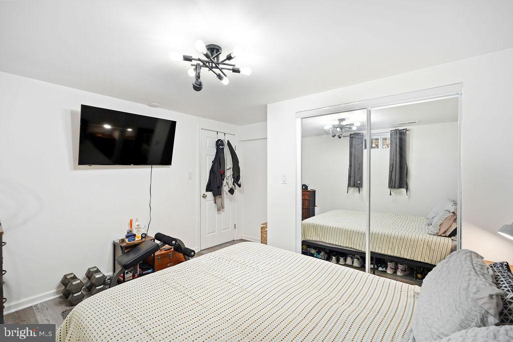 997 Mt Zion Marlboro Road Lothian, MD 20711 - Photo 50 of 58 a bedroom with a bed a flat screen tv and guitar