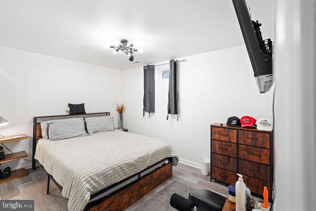 997 Mt Zion Marlboro Road Lothian, MD 20711 - Photo 51 of 58 a bedroom with a bed and a chandelier