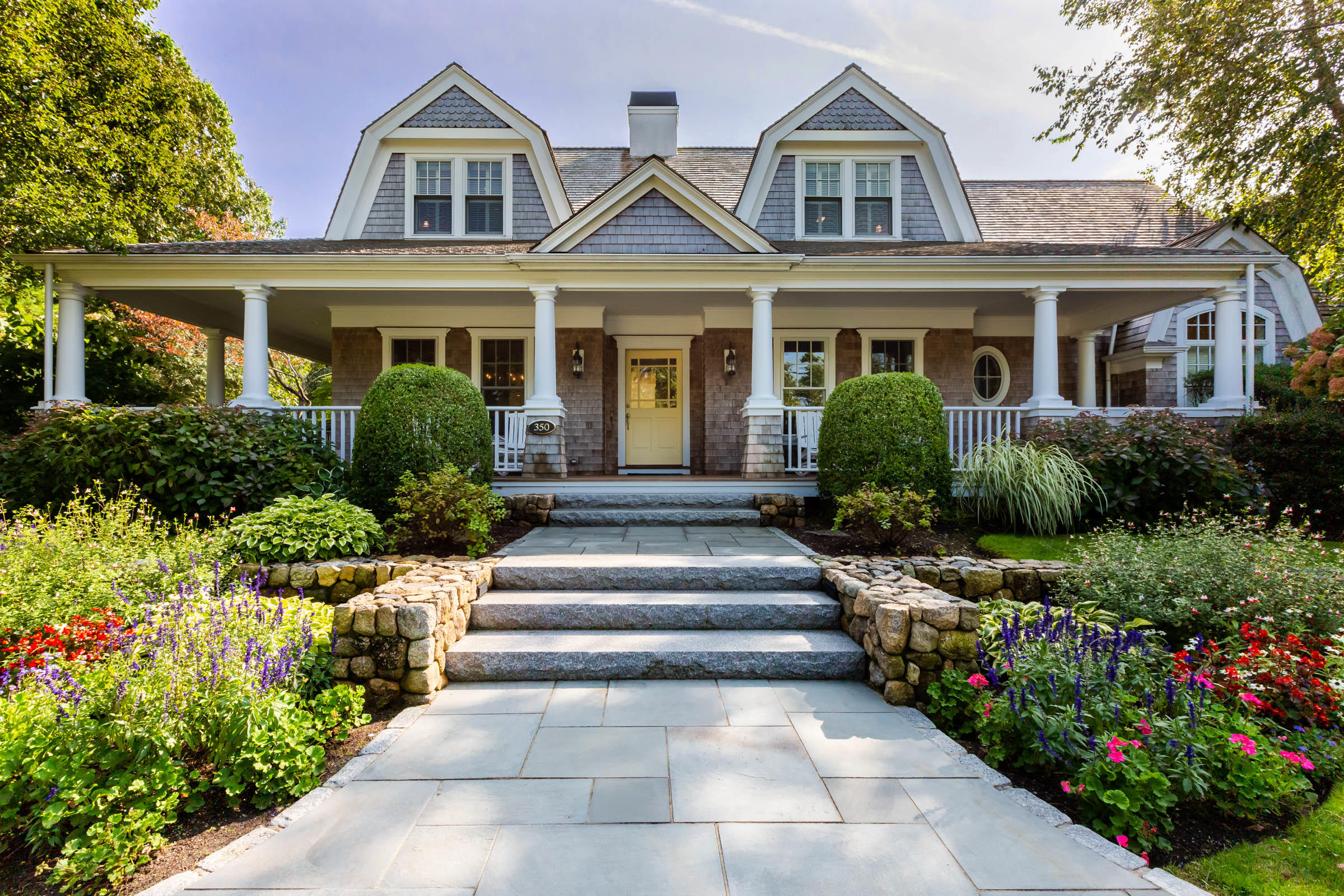 350 Windswept Way Osterville, MA 02655 - Photo 3 of 47 a front view of a house with a yard and flower plants