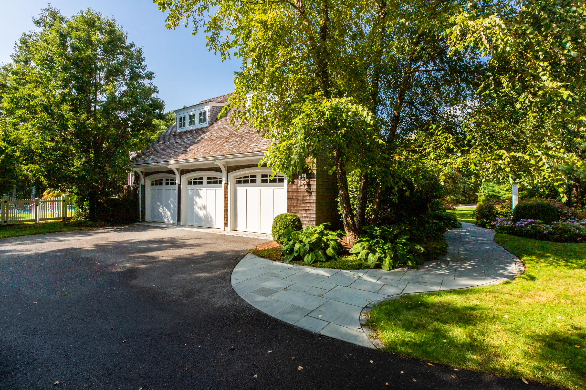 350 Windswept Way Osterville, MA 02655 - Photo 46 of 47 a front view of a house with a yard garage and outdoor seating
