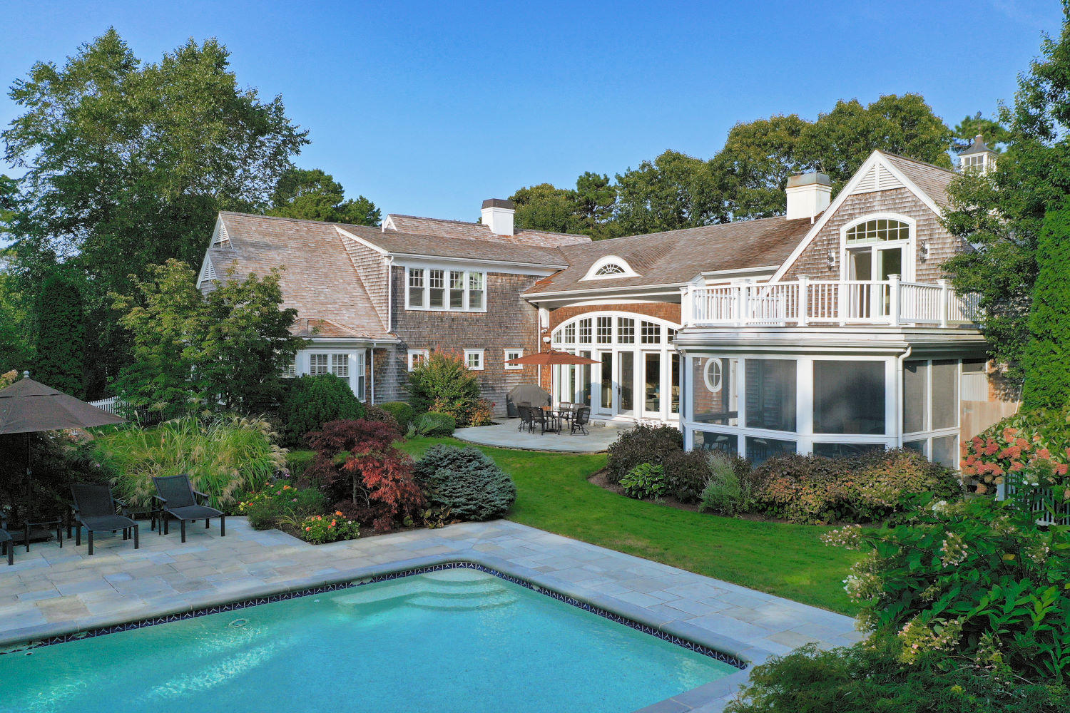 350 Windswept Way Osterville, MA 02655 - Photo 5 of 47 a front view of a house with a yard table and chairs