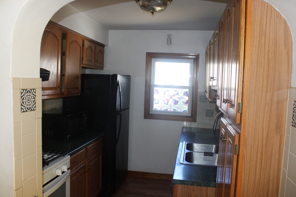136 Horton Street, Unit 1 Fall River, MA 02723 - Photo 17 of 17 a kitchen with a refrigerator and window