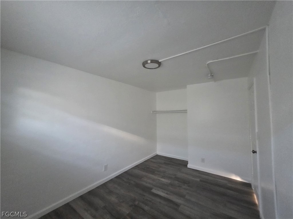 3033 2nd Street, Unit 2 Fort Myers, FL 33916 - Photo 1 of 9 an empty room with wooden floor and windows