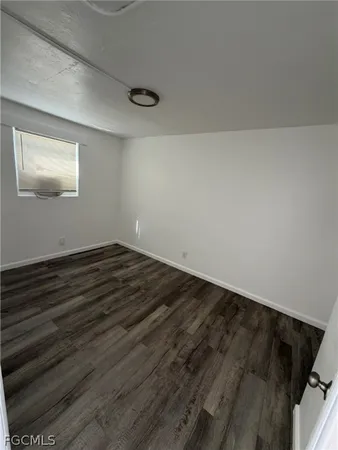 a view of a room with wooden floor