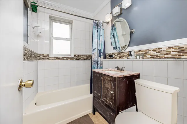 a bathroom with a toilet a sink and bathtub