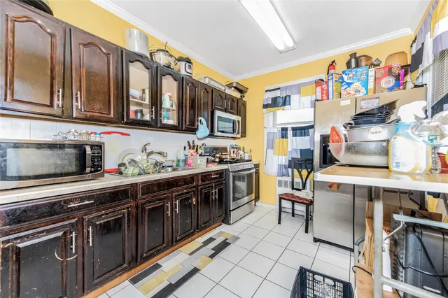 a kitchen with stainless steel appliances a stove and a sink