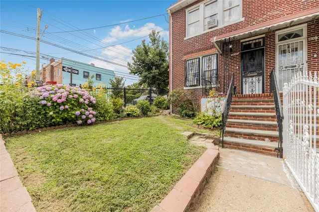 a view of a house with potted plants