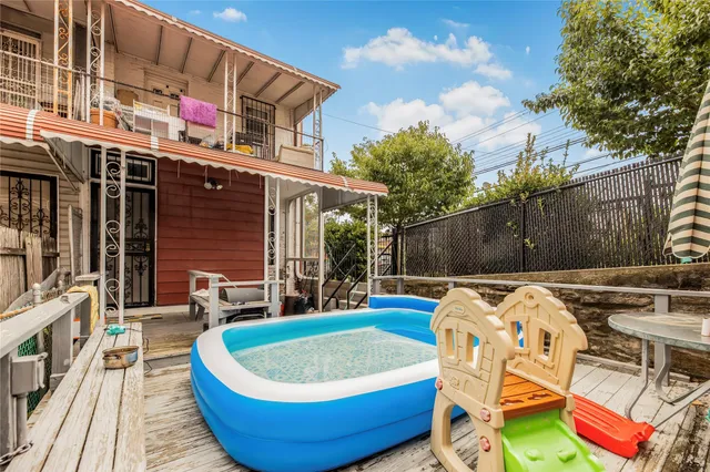 a swimming pool with outdoor seating and yard