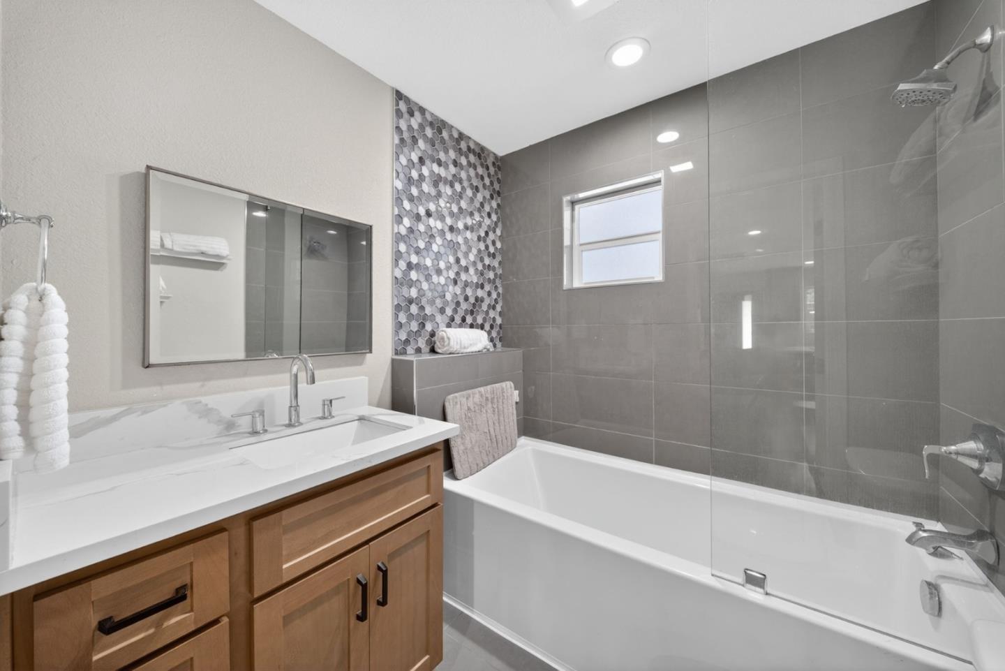 919 Old Canyon Road Fremont, CA 94536 - Photo 38 of 55 a bathroom with a tub sink and mirror
