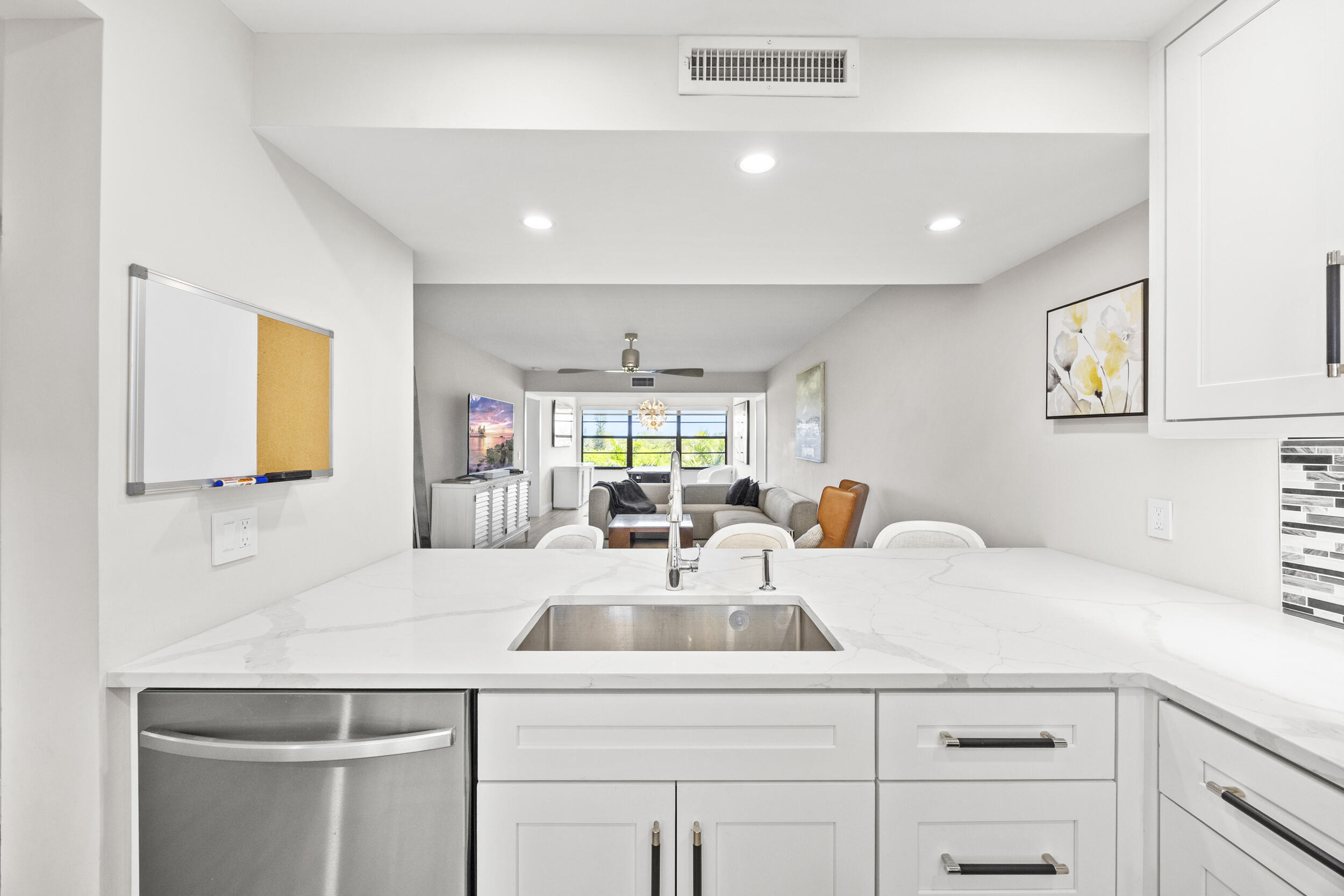 6061 Balboa Circle, Unit 403 Boca Raton, FL 33433 - Photo 11 of 44 a kitchen with a sink a stove and cabinets