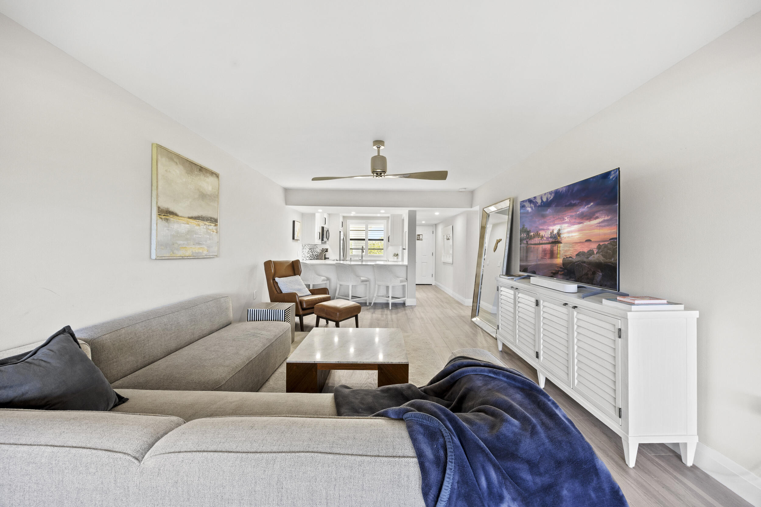 6061 Balboa Circle, Unit 403 Boca Raton, FL 33433 - Photo 17 of 44 a living room with furniture and a flat screen tv