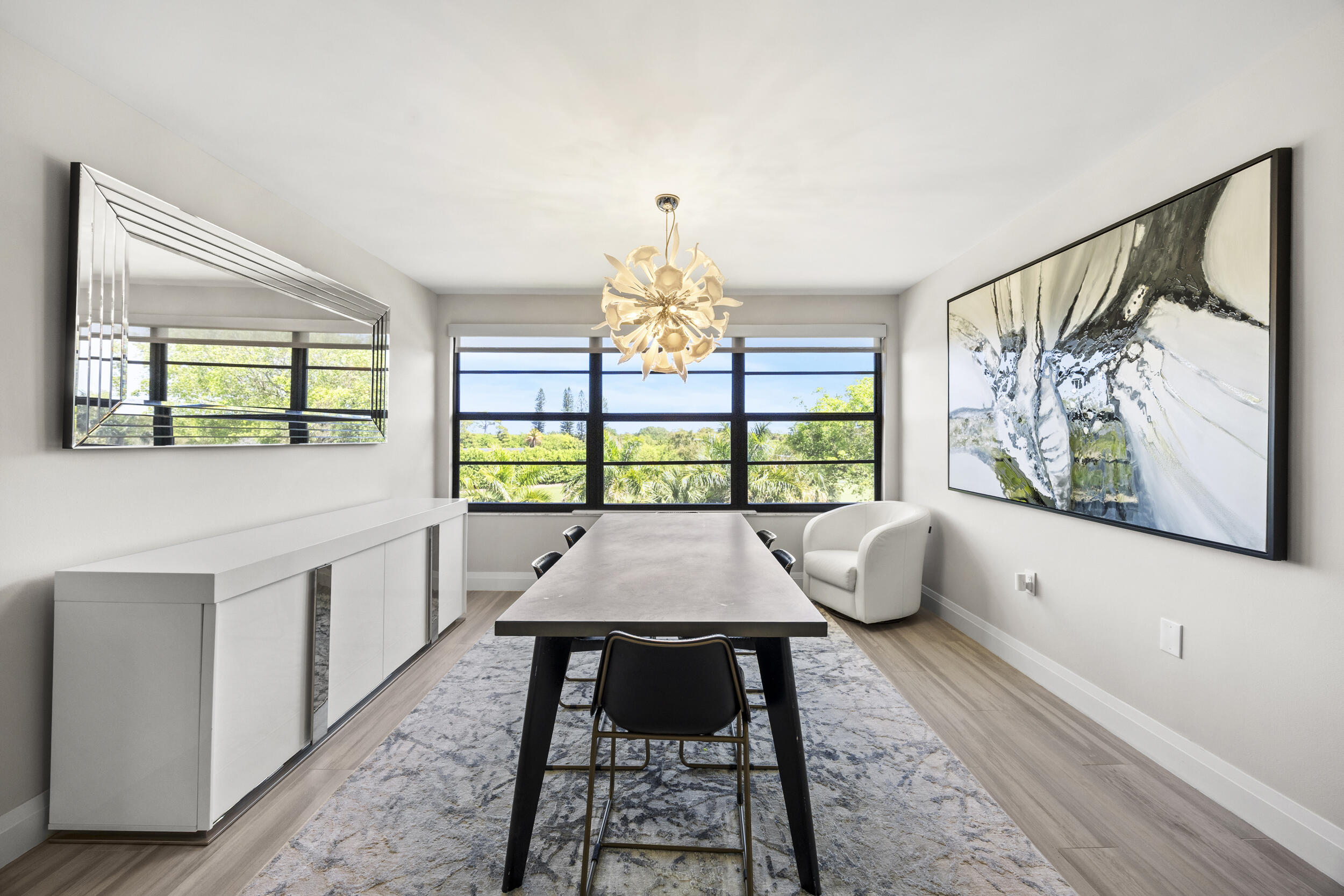 6061 Balboa Circle, Unit 403 Boca Raton, FL 33433 - Photo 19 of 44 a dining room with wooden floor and large windows