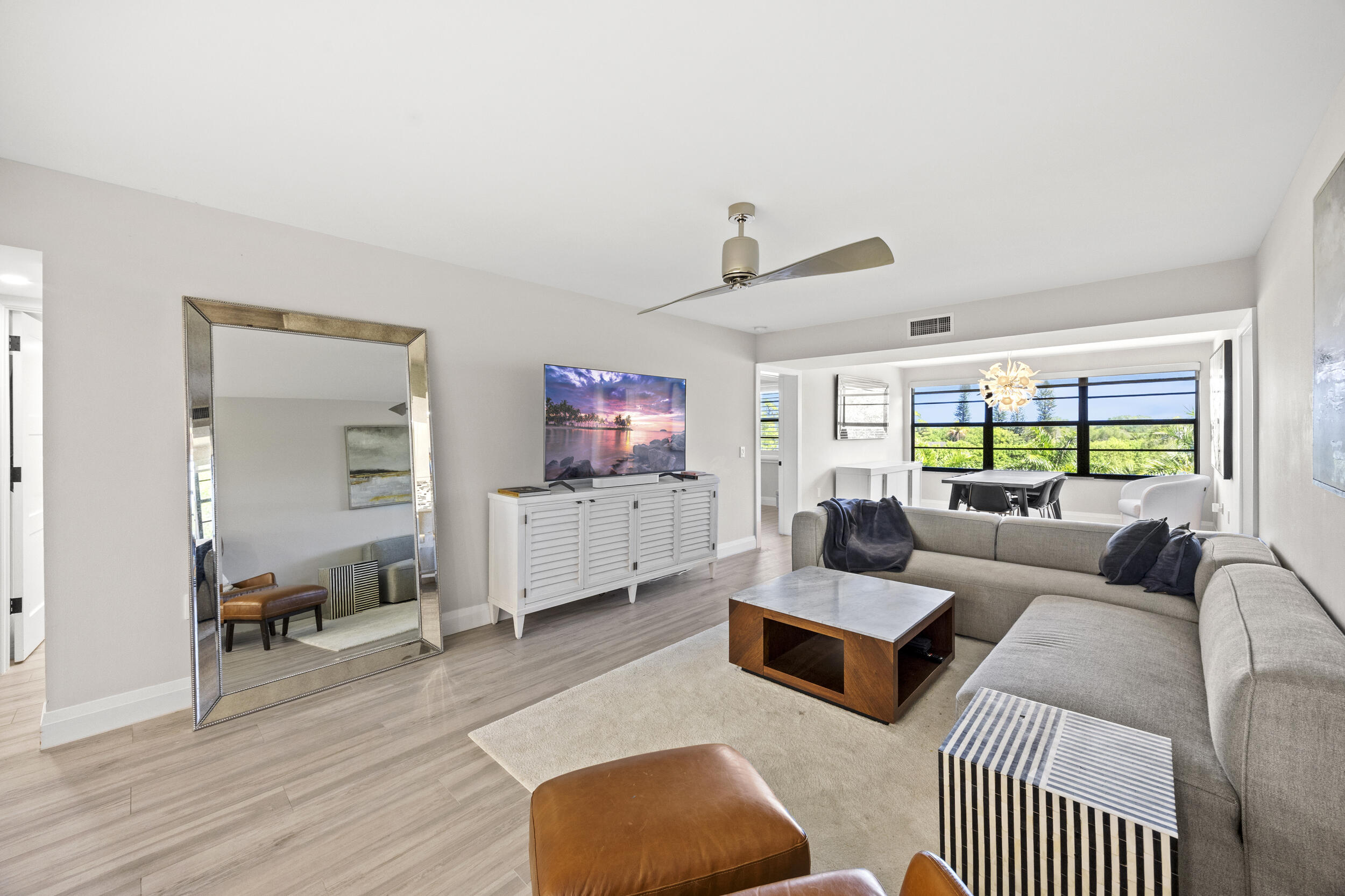 6061 Balboa Circle, Unit 403 Boca Raton, FL 33433 - Photo 2 of 44 a living room with furniture and a wooden floor